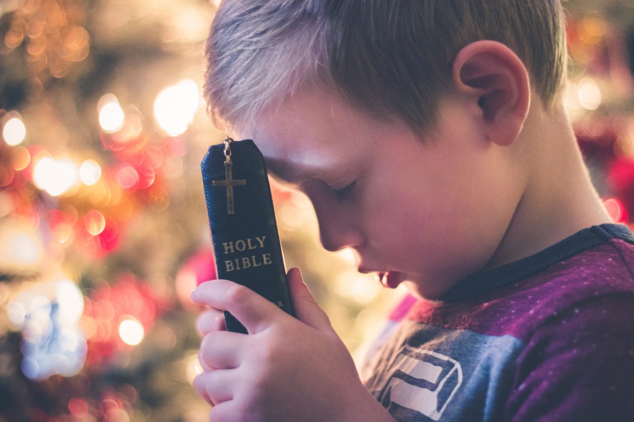 Child bible praying
